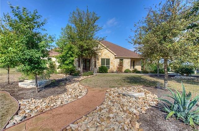 Exterior Front of home with xeriscaped lawn on 1.02 acres
