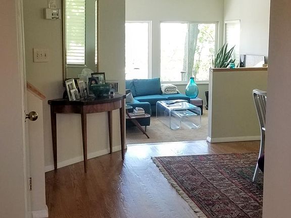 Entry to open floor plan with sunken living room
