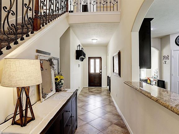 You will enter the home through a leaded glass and wood front door that allows plenty of natural light into the foyer. There is 18 inch diagonal tile in the entry.