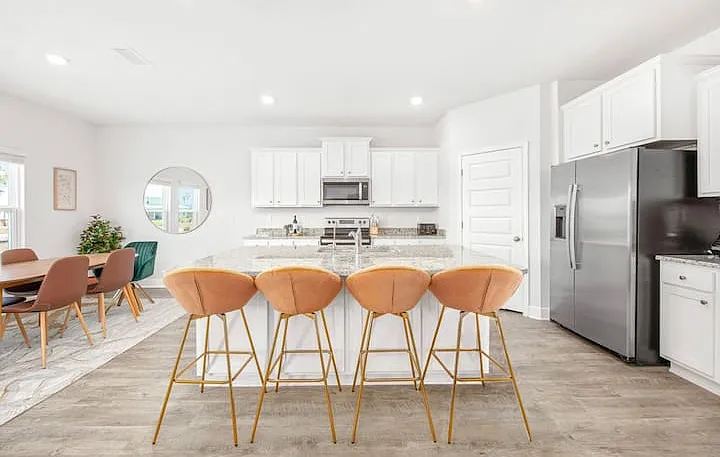 Open kitchen to living space with indoor seating for 10.
