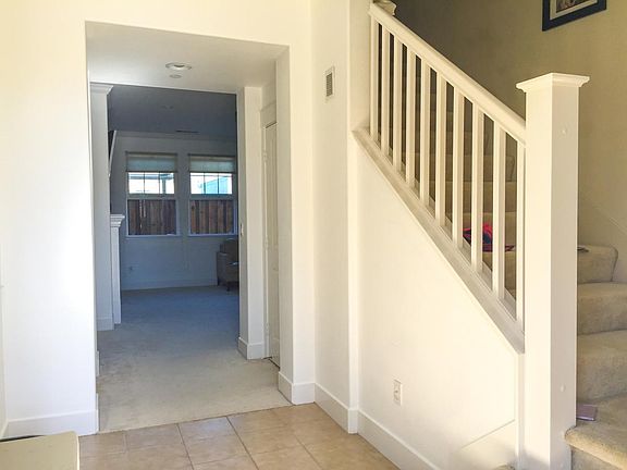 Bright entry to living room and stairwell.