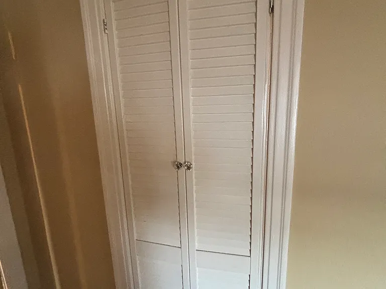 Door towards the walk in closet in the main bedroom.