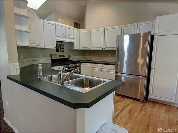 Updated bright kitchen with skylight and stainless appliance