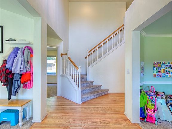 Open entry with living room to the left and formal dining room to the right