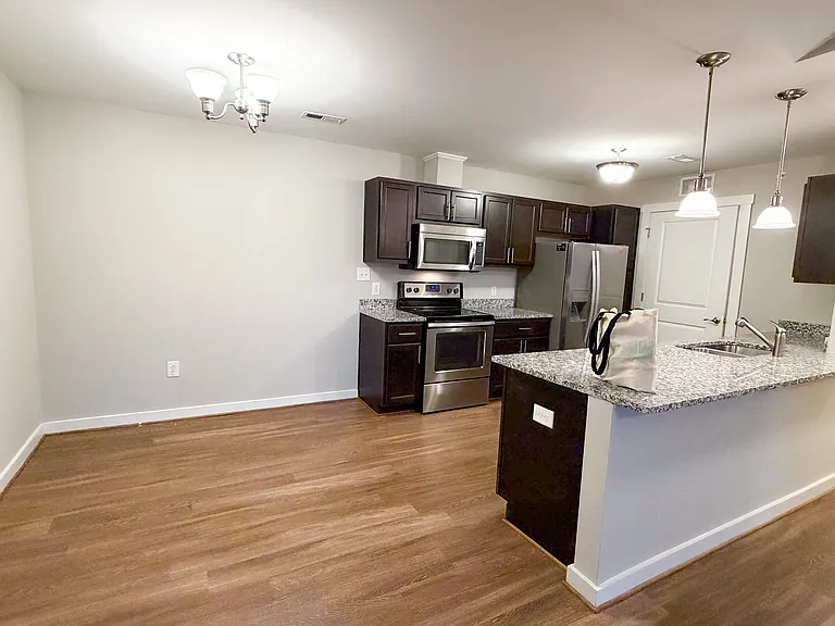 The open concept floorplan provides for a spacious dining, kitchen, and living space.