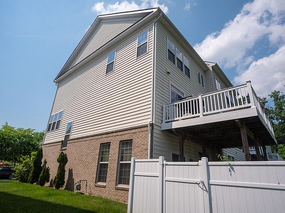 Side view with gated patio and large custom deck