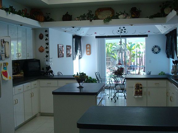 Bright open kitchen with breakfast room looking out onto screen porch