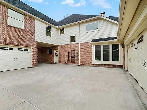 New garage doors and large driveway with side entry into the kitchen area!
