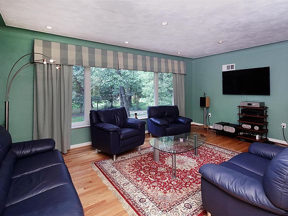 Lovely living room offers cove ceiling, large picture window and gleaming wood floors.