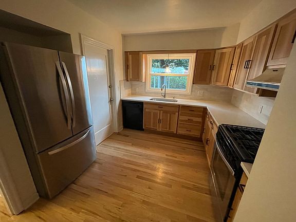 Newly remodeled kitchen with new refrigerator and gas range