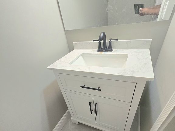 New modern sink and sleek 
black hardware and faucet in 1st floor 1/2 bath