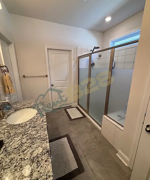 Primary bathroom with dual vanity and upgraded, extra-large walk-in shower