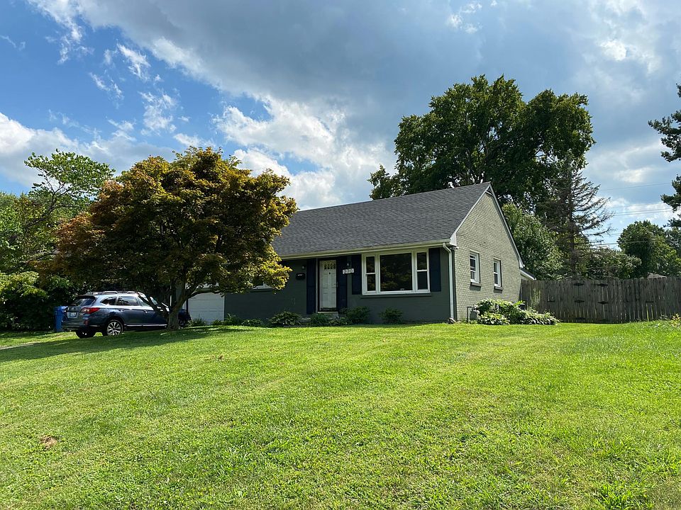 Beautiful front lawn with flaming red maple tree in fall. Lawn care is included in rent.