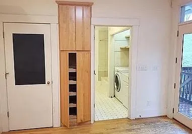 Portion of large new kitchen with adjacent bathroom and laundry room