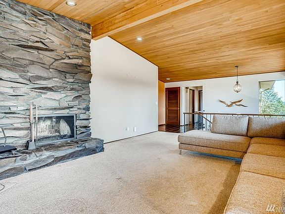 Wood burning classic stone fireplace in the expansive front room.