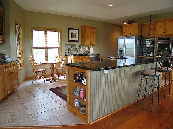 Granite kitchen with L-shaped center island.