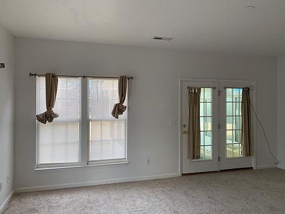 Very spacious living room opens to sun room and patio.