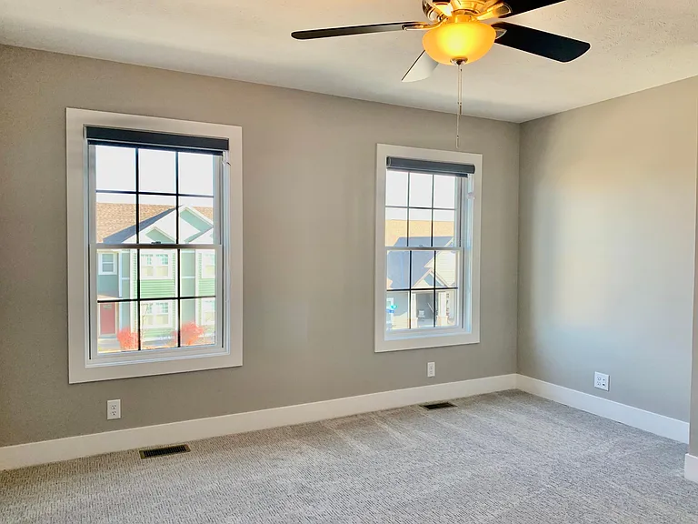 Double windows in the master bedroom allow natural light to stream in.