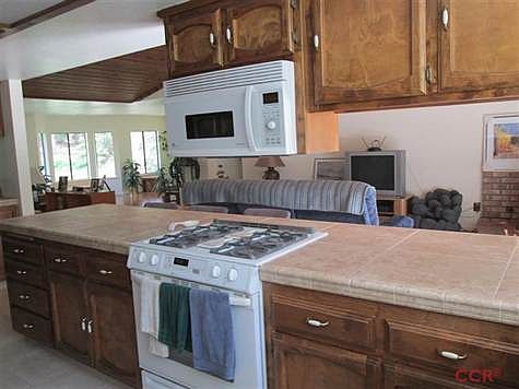 The kitchen appliances are like new with gas burners stove,electric oven and overhead micowave. New Tile counter tops including the Kitchen tile floors.