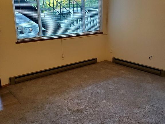 This is the Living Room, the photo is taken standing in the hallway, looking towards the living room. You will have a nice view of the front of the building and the nice trees out front.