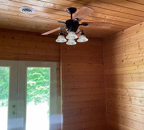 Living room with ceiling fan and french doors