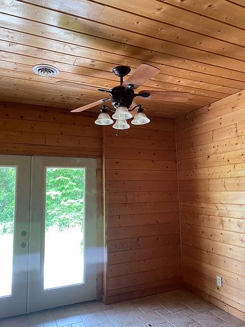 Living room with ceiling fan and french doors