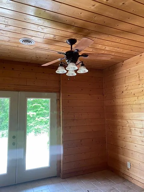 Living room with ceiling fan and french doors