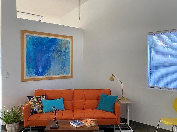 High ceilings, large windows, modern ceiling fans, and open floorplan give an expansive and interesting feel to the home.