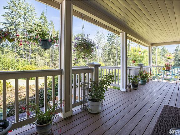 Imagine relaxing and sipping your favorite beverage in any season in this welcoming porch