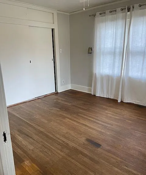 Hardwood floors throughout first floor and view of Bedroom #1 from living room.