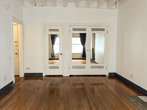 Living room with Murphy bed closed. Most of the tenants bring their own beds.