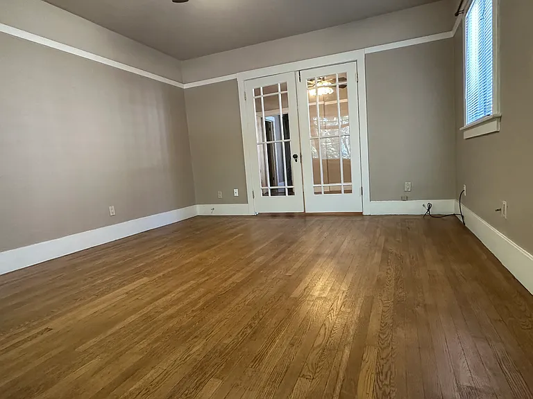 Original French doors separating the living room from the dining room.