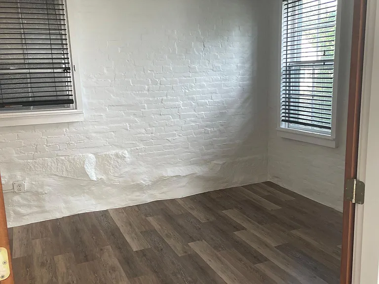 bedroom entrance with original brick walls.