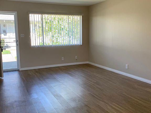 Spacious living room with bright front window