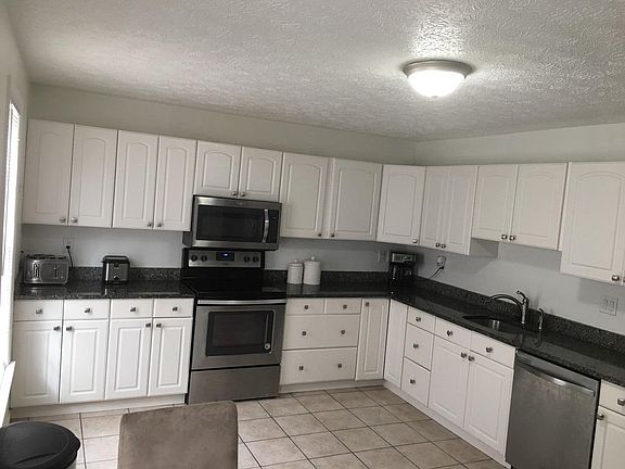 **New modern light fixture as well as an additional kitchen backsplash are being installed.