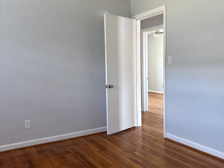First bedroom, has doors leading to hallway and directly to kitchen.