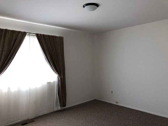 Bedroom 2, slightly smaller. Mirrored sliding door closet.