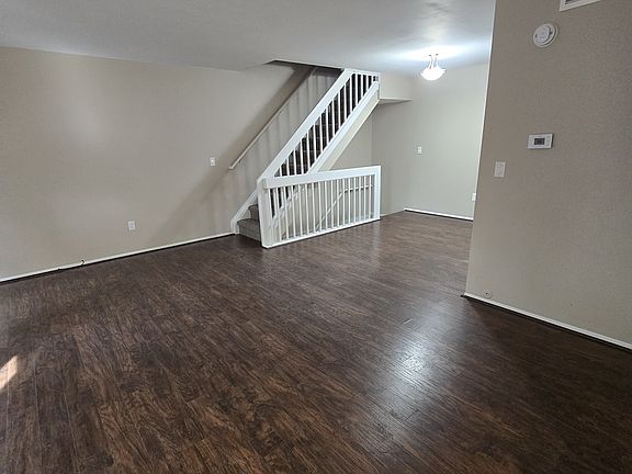 Living room and small dining area with laminate wood floors