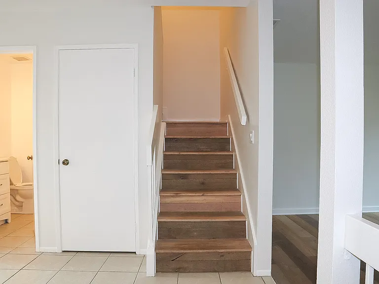 Guest bathroom on the left and the coat closet with extra storage under the stairs.