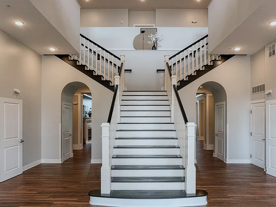 Step into luxury with this elegant foyer, highlighted by a stunning staircase design.