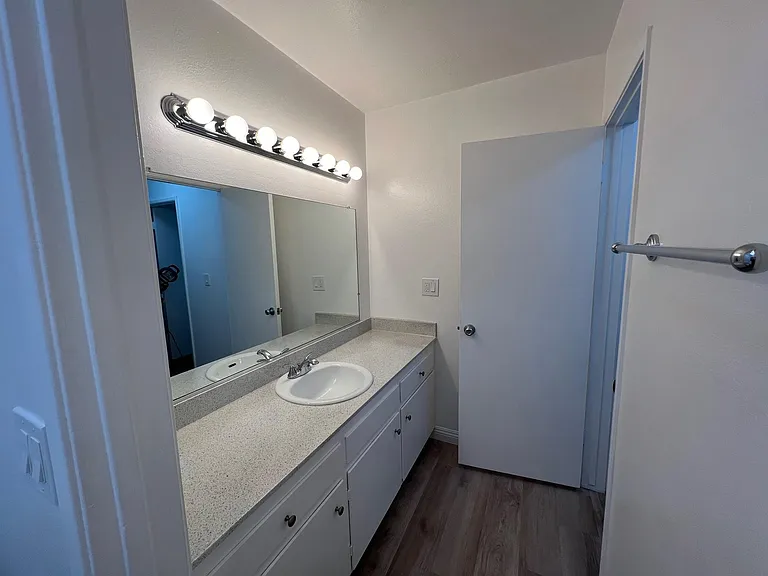 Standing in the private toilet and tub/shower area looking toward the vanity. 1x1