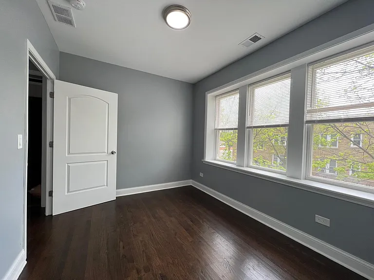2nd bedroom with built-in organizer closet and mirrored doors.