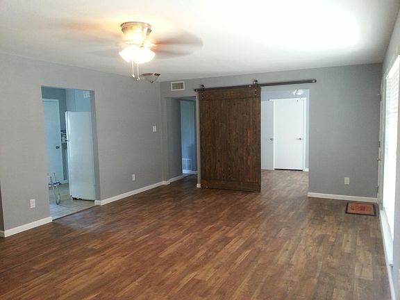 living room w/barn door open to living area