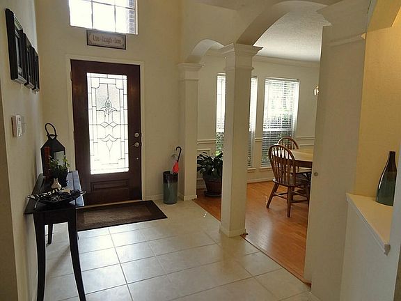  Leaded glass front door opens into a soaring 2-story foyer with ceramic tile floor.  Gorgeous arched openings & columns lead into the formal dining room.  Notice the lighted art niche (on the right). Home has a monitored alarm system.