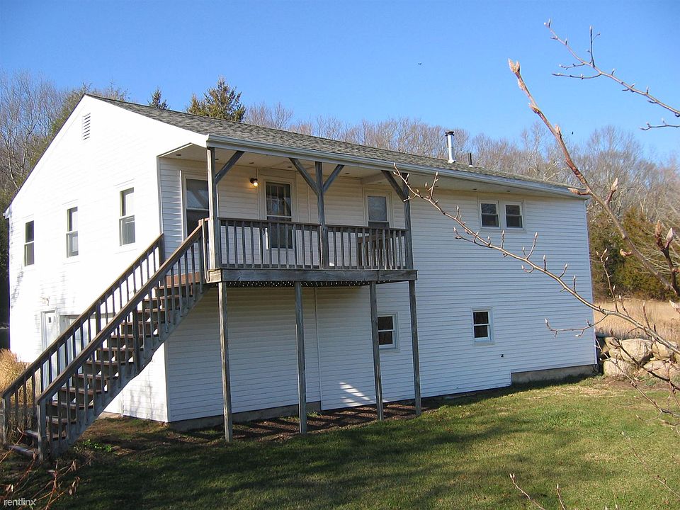 Front view - front door at top of porch; garage door(left si
