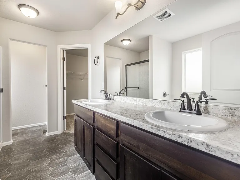 Primary 5 pc bathroom with His & Hers Sinks, toilet and walk in closet in background