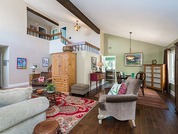 View of the living room formal dining area, upstairs and walkway on the left leads to the family roo