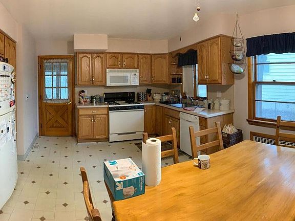 Large modern eat in kitchen with lots of counter space. Back door leads to enclosed porch. Does not show beautiful, just installed new ceramic tile floor.