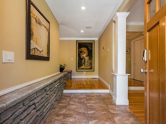 View from front door entry showcases intricate stonework, adding depth and character to the space.