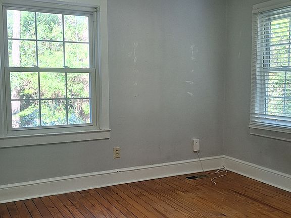 One of two bedrooms. Both about 12 x 12 with 2 windows, hardwood floors.